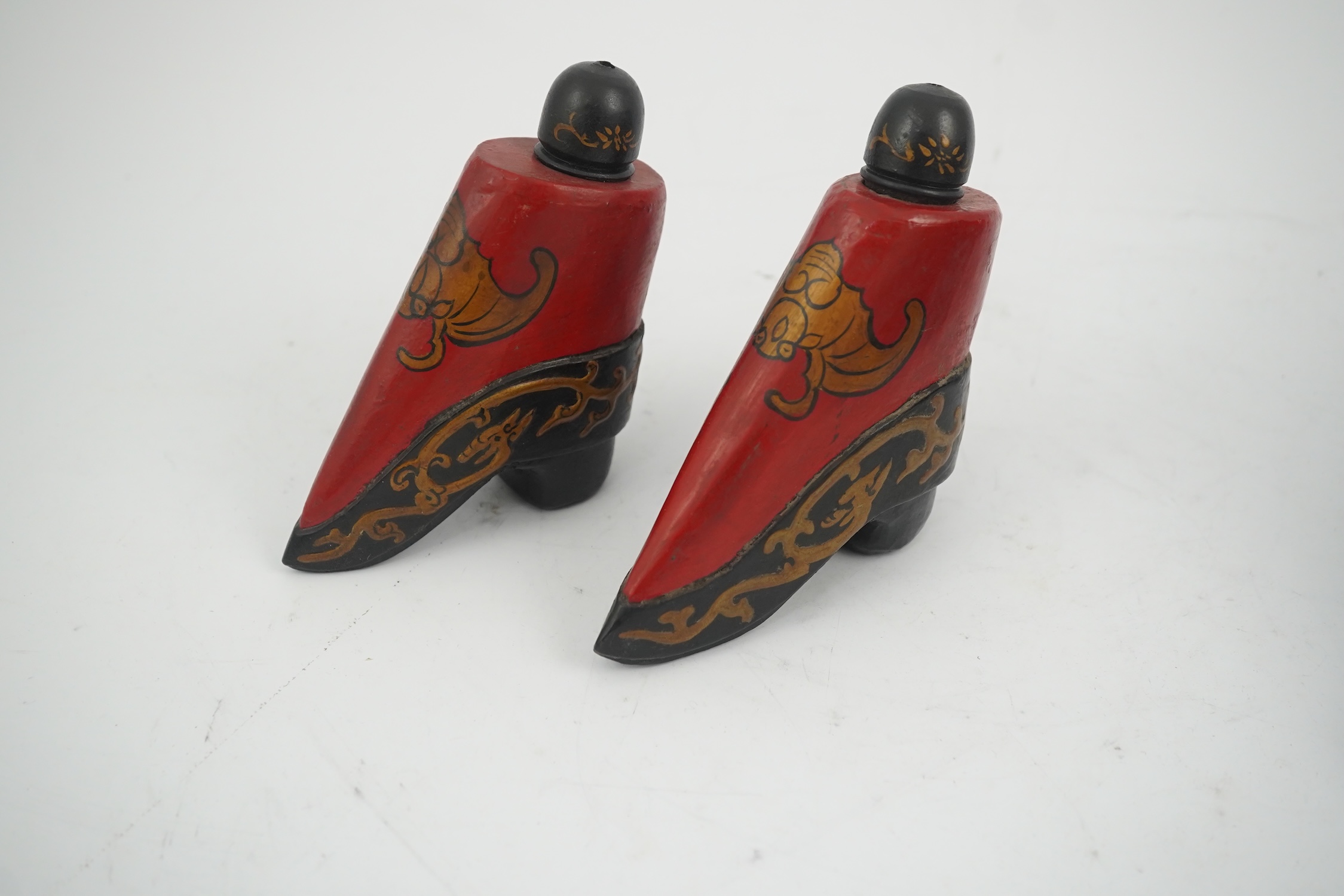 Three pairs of late 19th / early 20th century Chinese ladies embroidered silk shoes, for bound feet, one with sheep’s wool pom-poms, together with a similar a pair of silk embroidered ankle boots and pair of decorative r